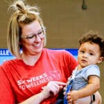 Woman holding child in Career Services at the Valley of The Sun YMCA - Donate Today.