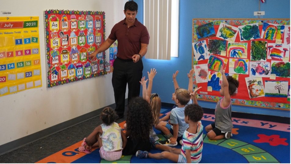 A man teaching kids to reach their potential