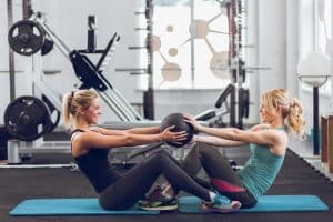 Two women using a weight ball | A Healthy New You!