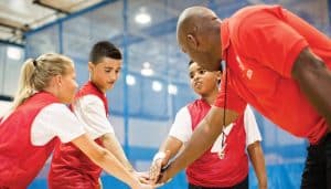 Children practicing teamwork in YMCA basketball